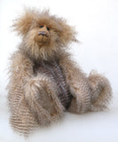 Cornelius Hoot sitting down. He is an endearingly sweet one of a kind, artist bear by Barbara-Ann Bears in wonderfully fluffy mohair and faux fur