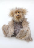 Cornelius Hoot sitting down. He is an endearingly sweet one of a kind, artist bear by Barbara-Ann Bears in wonderfully fluffy mohair and faux fur