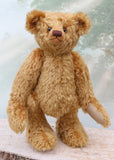 Brown teddy bear on a wooden surface with a blurred background