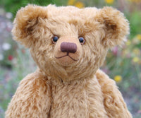Close-up of a teddy bear with a blurred natural background