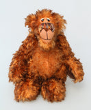 Denzel, a happy brown tipped ginger mohair artist bear by Barbara A Bears, photographed standing against a plain light grey background.