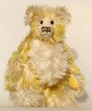 Dorothy teddy bear, a yellow and white hand dyed mohair teddy bear with a multicoloured nose against a white background