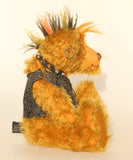 Ezra Plank, a punk Barbara Ann Bear in mustard gold with a mohawk, wearing a faux leather waistcoat