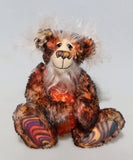 Flambé by Barbara Ann Bears, a handmade, distressed teddy bear with shaggy brown and orange fur, a cream-coloured stitched face, and colourful striped paw pads