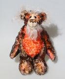Flambé by Barbara Ann Bears, a handmade, distressed teddy bear with shaggy brown and orange fur, a cream-coloured stitched face, and colourful striped paw pads