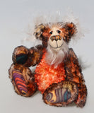 Flambé by Barbara Ann Bears, a handmade, distressed teddy bear with shaggy brown and orange fur, a cream-coloured stitched face, and colourful striped paw pads