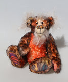 Flambé by Barbara Ann Bears, a handmade, distressed teddy bear with shaggy brown and orange fur, a cream-coloured stitched face, and colourful striped paw pads
