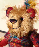Magnus the Haggis Charmer's beautifully hand painted eyes reflect his colouring as does his carefully embroidered nose. Magnus the Haggis Charmer has two beautiful feathers sew in behind his ear and another attached to the leaf charm he has around his neck