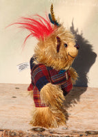 Magnus the Haggis Charmer is an extremely lovable, sweet and happy one of a kind artist bear made from beautiful batik mohair and tartan fabric by Barbara Ann Bears, he stands just 8 inches (20 cm) tall. Magnus is mainly made from a stylish woollen tartan together with a shaggy coffee and beige coloured batik mohair