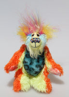Harry Tickle is a very happy and colourful little one of a kind, hand dyed mohair and faux fur artist bear by Barbara-Ann Bears, he stands 6.5 inches/16 cm tall. Harry Tickle is made from hand dyed mohair, with long plumes of faux fur on his head, hand painted eyes, a multicoloured nose and a beaming smile a happy bear!