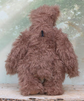 Hullabaloo standing viewed fom behind.
Hullabaloo is a very beary teddy bear a one of a kind, artist bear by Barbara-Ann Bears in wonderful brown faux fur and blonde mohair

Hullabaloo stands 15 inches/38 cm tall 