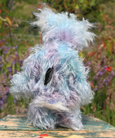 Hyssop is a gentle, happy teddy bear, a beautifully blue one of a kind, hand dyed mohair artist bear by Barbara-Ann Bears, he stands 9 inches/23 cm tall  Hyssop is mainly made from a fairly long, sparse hand dyed sky blue, coupled with a long fluffy white mohair with blue tipping and hand-dyed velvet paw pads.   Hyssop has beautiful hand painted eyes with eyelids, a nose embroidered from individual threads to complement his colouring and he has a huge, friendly smile. 