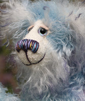 Hyssop is a gentle, happy teddy bear, a beautifully blue one of a kind, hand dyed mohair artist bear by Barbara-Ann Bears, he stands 9 inches/23 cm tall  Hyssop is mainly made from a fairly long, sparse hand dyed sky blue, coupled with a long fluffy white mohair with blue tipping and hand-dyed velvet paw pads.   Hyssop has beautiful hand painted eyes with eyelids, a nose embroidered from individual threads to complement his colouring and he has a huge, friendly smile. 