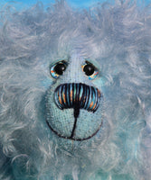 Kieran Cockles has beautiful hand painted slightly sparkling glass eyes (they were painted to match his mohair) with hand coloured eyelids, a wonderfully embroidered nose, sewn from individual threads to match his mohair and a humongous cheerful smile