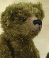 Kingsley Greenacre is a very sweet and cuddly one of a kind traditional artist teddy bear by Barbara Ann Bears in bottle green mohair he is 13 inches/33cm tall.  Kingsley Greenacre is made from a beautiful, distressed bottle green German mohair and he has German wool-felt paw pads that coordinate very well with his mohair. Kingsley has boot buttons for eyes, just like the really old teddy bears. He has a carefully embroidered nose and a sweet smile. 