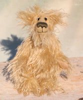 Plush teddy bear with a fluffy texture standing on a wooden surface 