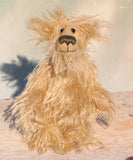 Plush teddy bear with a fluffy texture standing on a wooden surface 