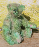 Logan sitting.
Logan is a very handsome traditional, one of a kind artist teddy bear in fabulous multi-shaded green hand dyed mohair by Barbara Ann Bears, he stands 14 inches/35cm tall 