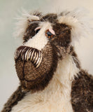 Nicholas Prickleless has beautiful hand painted slightly sparkling glass eyes (they were painted to complement his mohair) with eyelids, a wonderful nose embroidered with individual threads to match his mohair and a broad and cheerful smile