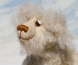 Otis is a sweet and very friendly, one of a kind, artist teddy bear in beautiful long pearl coloured mohair by Barbara-Ann Bears he stands 11 inches/28 cm tall .
Otis is made from a sumptuous, long, very dense, scruffily twirly, nearly white mohair and he has matching pale cream coloured German wool felt paw pads.