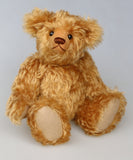 Owen, a traditional antique gold teddy bear on a light grey background