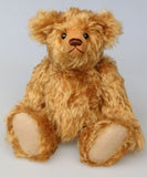 Owen, a traditional antique gold teddy bear on a light grey background