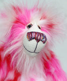 Pamela Pinkerton a colourful teddy bear with pink and white fur and a multicoloured mouth on a white background, close-up of face