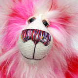 Pamela Pinkerton a colourful teddy bear with pink and white fur and a multicoloured mouth on a white background, close-up of face