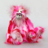 Pamela Pinkerton a colourful teddy bear with pink and white fur and a multicoloured mouth on a white background