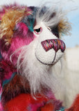 Pepper is a sweet and colourful one of a kind, artist teddy bear in fabulous faux fur and gorgeous mohair by Barbara-Ann Bears and stands 12.5 inches/32 cm tall.   He is made from faux fur in bands of rusty orange, magenta, aqua and a deep mauve, with long, white mohair, turquoise paws, hand painted eyes, a beautifully embroidered nose and a charming smile