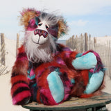 Pepper is a sweet and colourful one of a kind, artist teddy bear in fabulous faux fur and gorgeous mohair by Barbara-Ann Bears and stands 12.5 inches/32 cm tall.   He is made from faux fur in bands of rusty orange, magenta, aqua and a deep mauve, with long, white mohair, turquoise paws, hand painted eyes, a beautifully embroidered nose and a charming smile