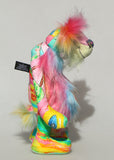 Plinkety Plonk by Barbara Ann Bears standing up in profile. He's a wildly colourful bear in printed fabric, long fluffy mohair and very long multi coloured faux fur.