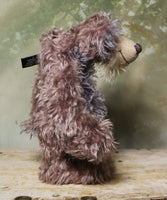 Priscilla Proon standing viewed in profile. Priscilla Proon is a calm and thoughtful beautifully coloured one of a kind artist bear in gorgeous rose and grey hand dyed mohair by Barbara Ann Bears she stands 12 inches( 30cm) tall