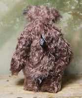 Priscilla Proon standing viewed from behind. Priscilla Proon is a calm and thoughtful beautifully coloured one of a kind artist bear in gorgeous rose and grey hand dyed mohair by Barbara Ann Bears she stands 12 inches( 30cm) tall