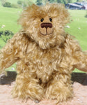 Robbie McFluff is a cute and quite little one of a kind artist bear in wildly curly mohair by Barbara-Ann Bears, he stands just 7 inches(18 cm) tall and is 5.5 inches (14 cm) sitting. Robbie is made from wonderful, wildly curly beige gold mohair, with a slightly warmer backcloth and he has beige German wool felt paw pads 