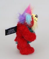 Rudi Ruffles is a very happy little teddy bear, a one of a kind, mohair and faux fur artist bear by Barbara-Ann Bears, is quite a little bear, he stands just 5.5 inches/14 cm tall. He is made from a short red German mohair, with hand dyed yellow and blue mohair and soft sky blue faux fur with black Jaguar-like rosettes