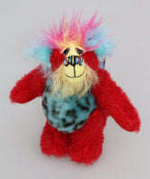 Rudi Ruffles is a very happy little teddy bear, a one of a kind, mohair and faux fur artist bear by Barbara-Ann Bears, is quite a little bear, he stands just 5.5 inches/14 cm tall. He is made from a short red German mohair, with hand dyed yellow and blue mohair and soft sky blue faux fur with black Jaguar-like rosettes