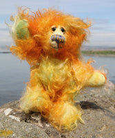 Rudi Blooms is a sweet and beautifully coloured one of a kind teddy bear in hand dyed mohair by Barbara-Ann Bears, he stands just 6.5 inches/16 cm tall. He is made from a fairly a long tousled mohair hand-dyed in orange, gold, pale green, amber and blue. He has hand dyed paw pads, hand painted eyes and a sweet little embroidered nose and a sweet smile.