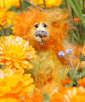 Rudyard Edgar Bloom Sniffer is a sweet and beautifully coloured one of a kind teddy bear in hand dyed mohair by Barbara-Ann Bears, he stands just 6.5 inches/16 cm tall. He is made from a fairly a long tousled mohair hand-dyed in orange, gold, pale green, amber and blue. He has hand dyed paw pads, hand painted eyes and a sweet little embroidered nose and a sweet smile.