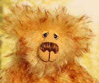 Rutherford is made from long, dense, brown tipped gold mohair. He has beautiful hand painted, twinkling, glass eyes with hand coloured eyelids, a splendid nose embroidered from individual threads and a happy, hopeful expression