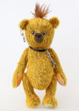 Scuggs is an endearingly sweet and gently wild beautifully coloured one of a kind, mohair artist bear by Barbara-Ann Bears, he stands 13 inches/33 cm tall and is 10.5 inches/26 cm sitting. He is made from gold mohair which has a dark brown backcloth, with a mohawk, hand dyed paw pads, and hand painted eyes with eyelids