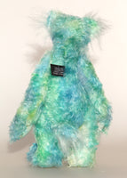 Sebastian Swoon is an elegant and beautifully coloured one of a kind, hand dyed mohair artist bear by Barbara-Ann Bears, he stands 14 inches/36 cm tall and is 10.5 inches/26 cm sitting.He is made from mohair hand dyed in shades of blue, green, turquoise and lime, His face, the fronts of his ears and the underside of his tail are made from a long, fluffy white faux fur and he has hand dyed velvet paws
