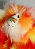 Sunny is made from a beautiful faux fur in bright yellow, orange and red, his face the fronts of his ears and the underside of his tail are a long white fluffy mohair and he has bright gold wool felt paw pads. Sunny has beautiful hand painted glass eyes with eyelids, a wonderfully embroidered nose, sewn from individual threads to match his colouring and he has a huge beaming smile