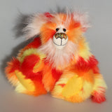 Sunny is a flamboyant, fun-loving and comical, one of a kind, artist bear by Barbara-Ann Bears in luxurious mohair and beautifully colourful faux fur and he stands 11.5 inches/29 cm tall and is 9 inches/23cm sitting.  Sunny is made from a beautiful faux fur in bright yellow, orange and red, his face the fronts of his ears and the underside of his tail are a long white fluffy mohair and he has bright gold wool felt paw pads
