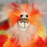 Sunny is made from a beautiful faux fur in bright yellow, orange and red, his face the fronts of his ears and the underside of his tail are a long white fluffy mohair and he has bright gold wool felt paw pads. Sunny has beautiful hand painted glass eyes with eyelids, a wonderfully embroidered nose, sewn from individual threads to match his colouring and he has a huge beaming smile