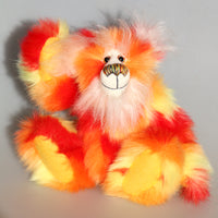 Sunny is a flamboyant, fun-loving and comical, one of a kind, artist bear by Barbara-Ann Bears in luxurious mohair and beautifully colourful faux fur and he stands 11.5 inches/29 cm tall and is 9 inches/23cm sitting.  Sunny is made from a beautiful faux fur in bright yellow, orange and red, his face the fronts of his ears and the underside of his tail are a long white fluffy mohair and he has bright gold wool felt paw pads