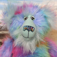 Syracuse's face. showing his beautiful hand painted eyes (with eyelids), wonderfully embroidered nose and sweet smile.
Syracuse is a large and beautifully coloured one of a kind artist bear by Barbara Ann Bears in luxurious multi-coloured fluffy faux fur and very long, turquoise mohair he stands 19 inches/48 cm tall