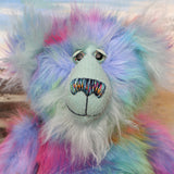 Syracuse's face. showing his beautiful hand painted eyes (with eyelids), wonderfully embroidered nose and sweet smile.
Syracuse is a large and beautifully coloured one of a kind artist bear by Barbara Ann Bears in luxurious multi-coloured fluffy faux fur and very long, turquoise mohair he stands 19 inches/48 cm tall