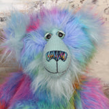 Syracuse's face. showing his beautiful hand painted eyes (with eyelids), wonderfully embroidered nose and sweet smile.
Syracuse is a large and beautifully coloured one of a kind artist bear by Barbara Ann Bears in luxurious multi-coloured fluffy faux fur and very long, turquoise mohair he stands 19 inches/48 cm tall