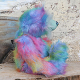 Syracuse sitting, viewed from the side, showing his profile.
Syracuse is a large and beautifully coloured one of a kind artist bear by Barbara Ann Bears in luxurious multi-coloured fluffy faux fur and very long, turquoise mohair he stands 19 inches/48 cm tall